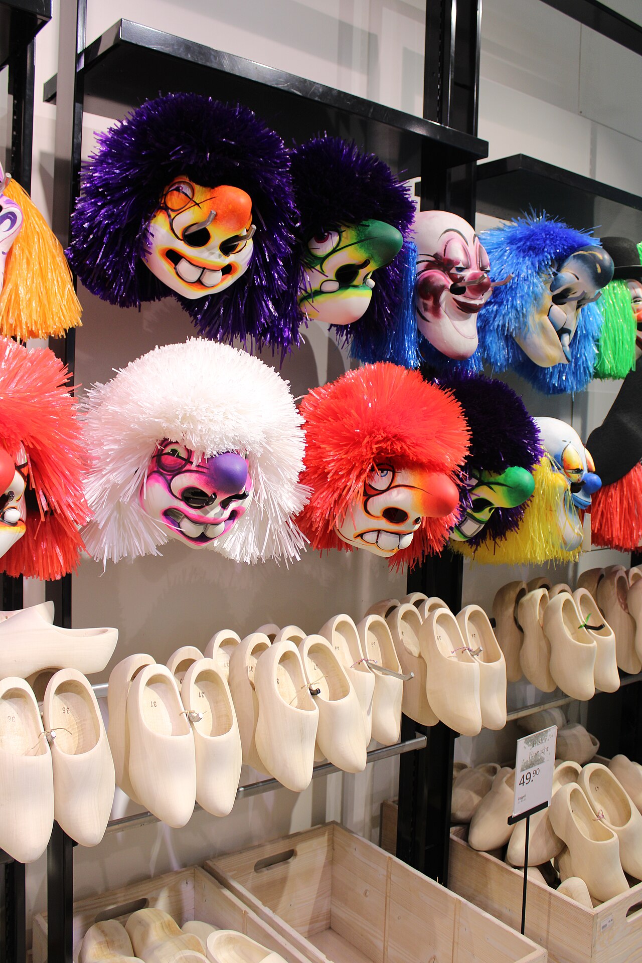 Swiss Commercial Register Shows AI Claim Surge in New Companies — Commercially produced masks and Zoggeli (typical Swiss wood shoes) for sale during Basler Fasnacht 2024