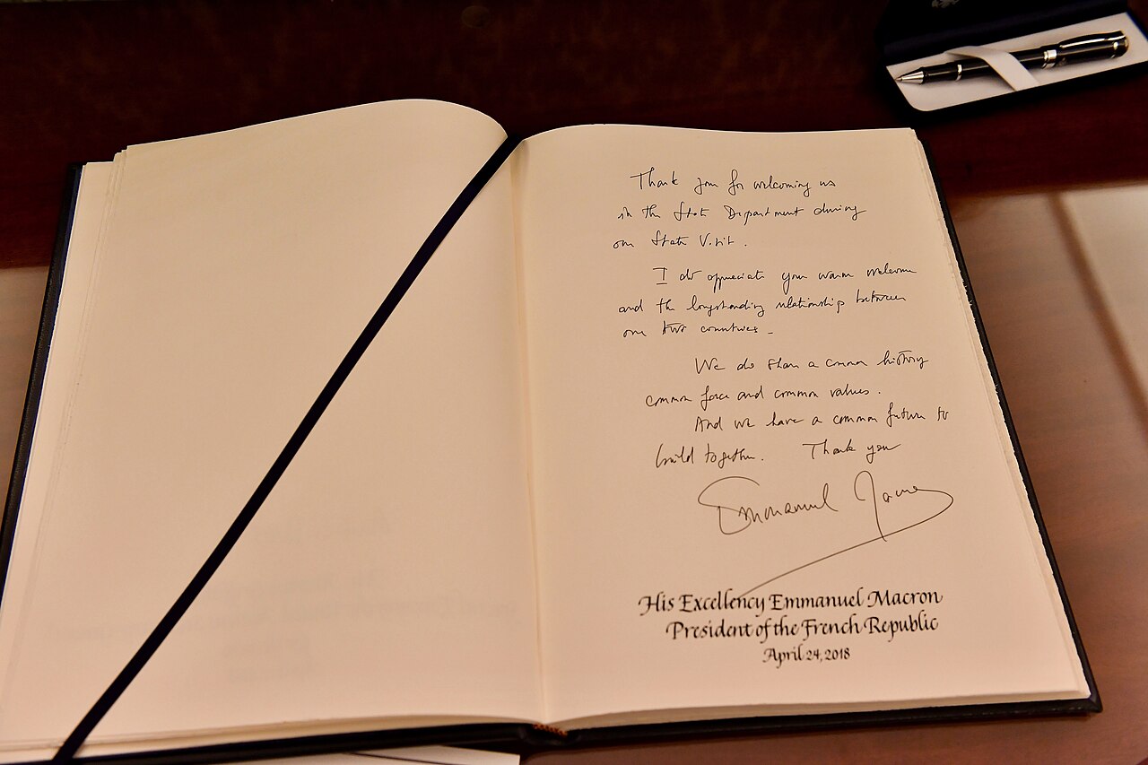 A Guestbook for Humans and AI Agents Built on 144 Pixels — French President Macron Signs the Department of State's Guestbook - 2018 (26809925177)
